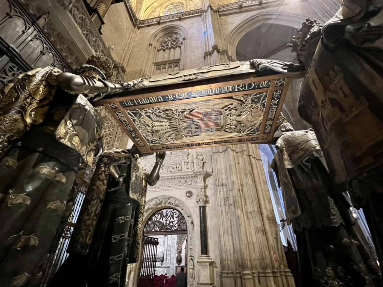 Columbus' tomb held aloft by four figures representing the 4 kingdoms of Spain