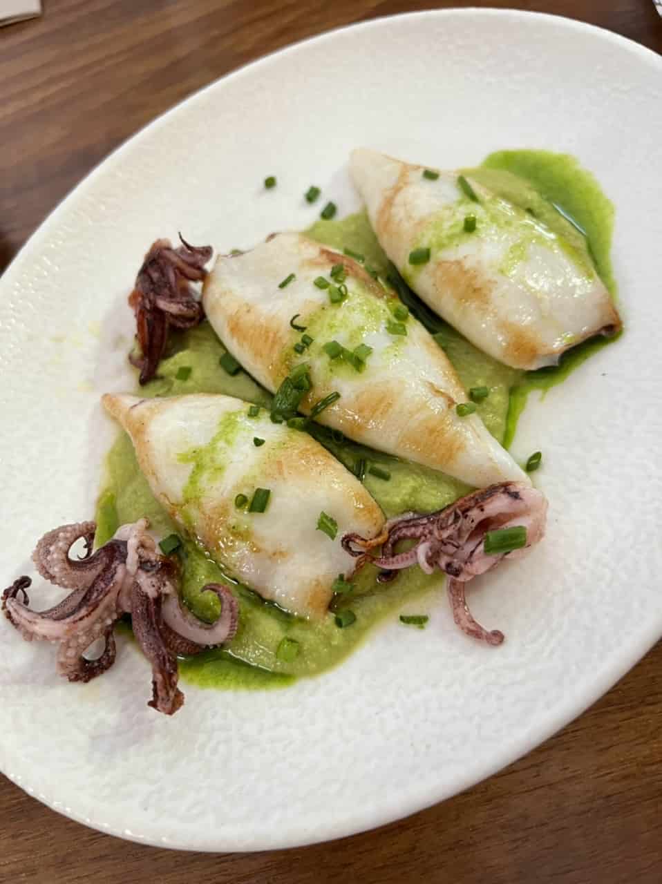 A tapa of grilled squid atop pea puree