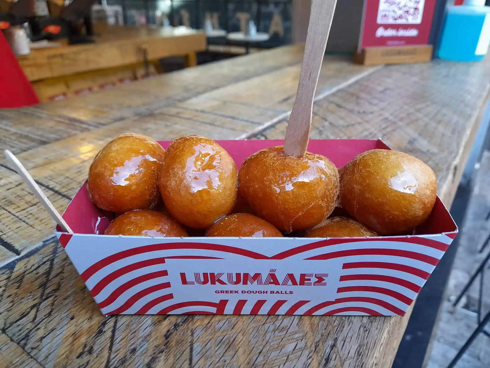 Loukoumades with honey at Lukumades - an ancient street food in Athens